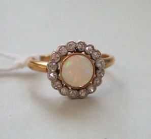 Appraisal: A gold opal and diamond set cluster ring collet set