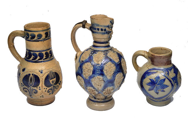 Appraisal: A GROUP OF THREE CONTINENTAL STONEWARE JUGS with blue glazed