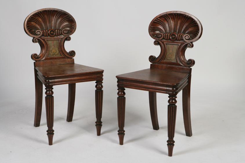 Appraisal: A PAIR OF EARLY VICTORIAN MAHOGANY HALL CHAIRS with shell-carved