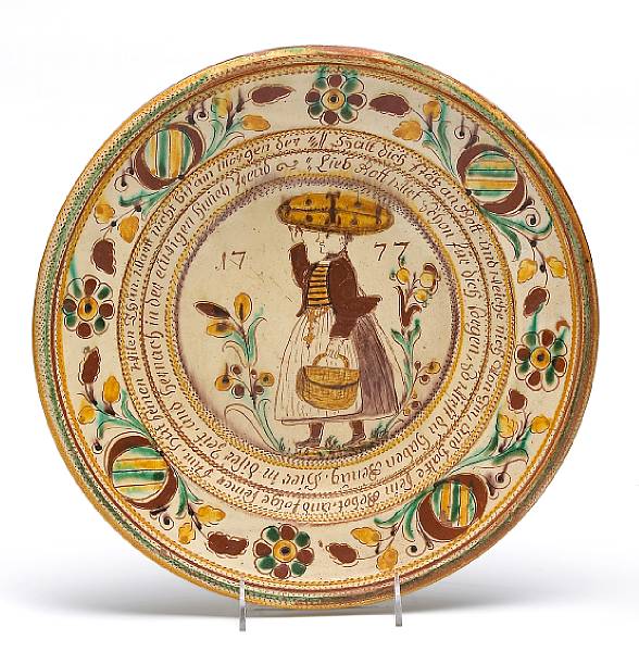 Appraisal: A sgraffito and slip decorated redware deep dish Centering a