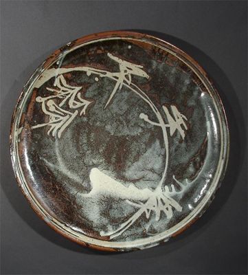 Appraisal: A large Frank Smith stoneware charger resist decorated with plant