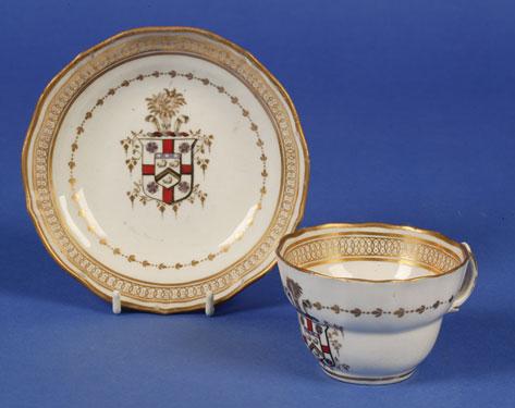 Appraisal: A NEW HALL ARMORIAL CUP AND SAUCER circa decorated in