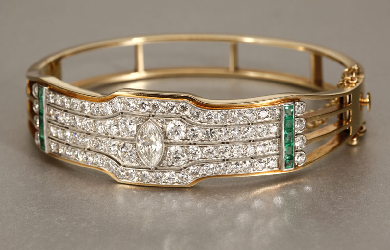 Appraisal: A K yellow gold emerald and diamond bangle A K