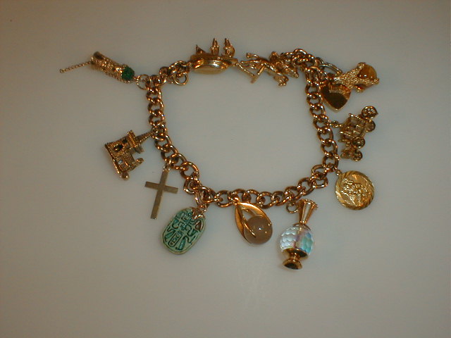 Appraisal: A charm bracelet eleven charms on a curb link bracelet