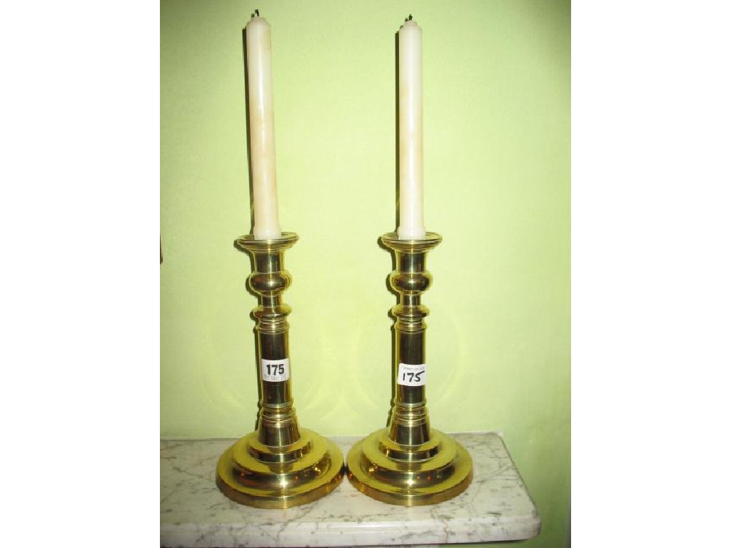 Appraisal: A PAIR OF LATE GEORGE III BRASS CANDLESTICKS with stepped