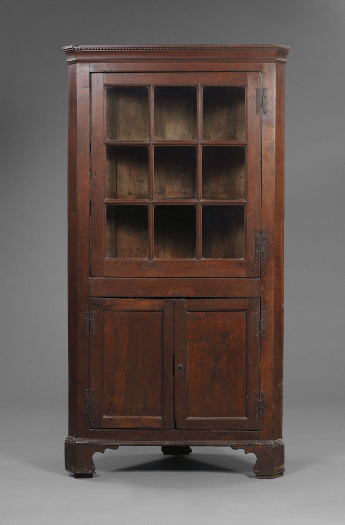 Appraisal: PENNSYLVANIA CHIPPENDALE WALNUT CORNER CUPBOARD The case with dentil and