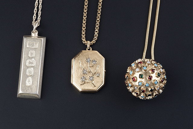 Appraisal: Three pendants on chains comprising a ct gold octagonal locket