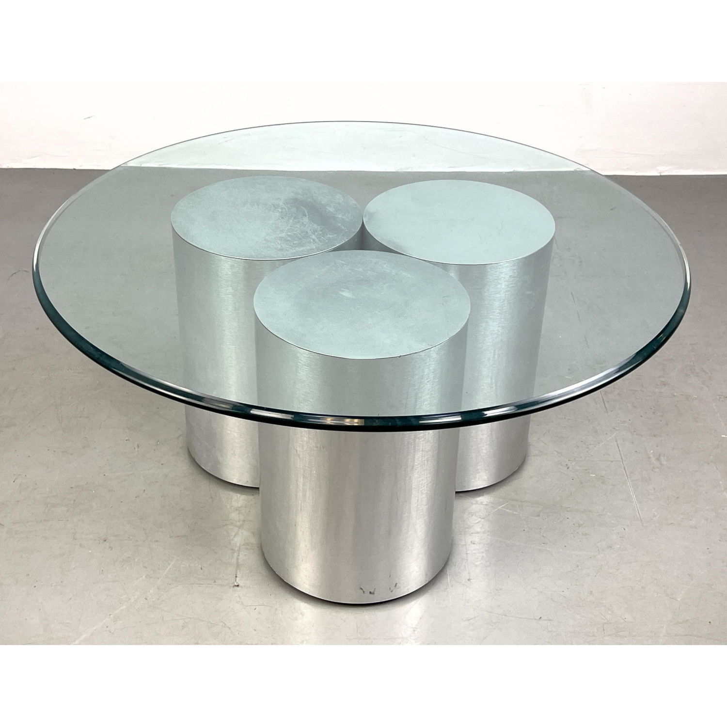 Appraisal: Round brushed chrome post modern cocktail coffee table Three connected