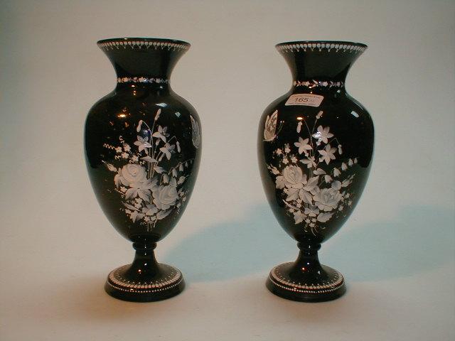 Appraisal: A pair of black glass vases with white floral enamelled