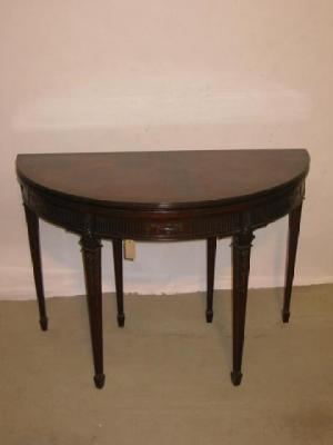 Appraisal: A MAHOGANY FOLDING CARD TABLE of demi lune form crossbanded