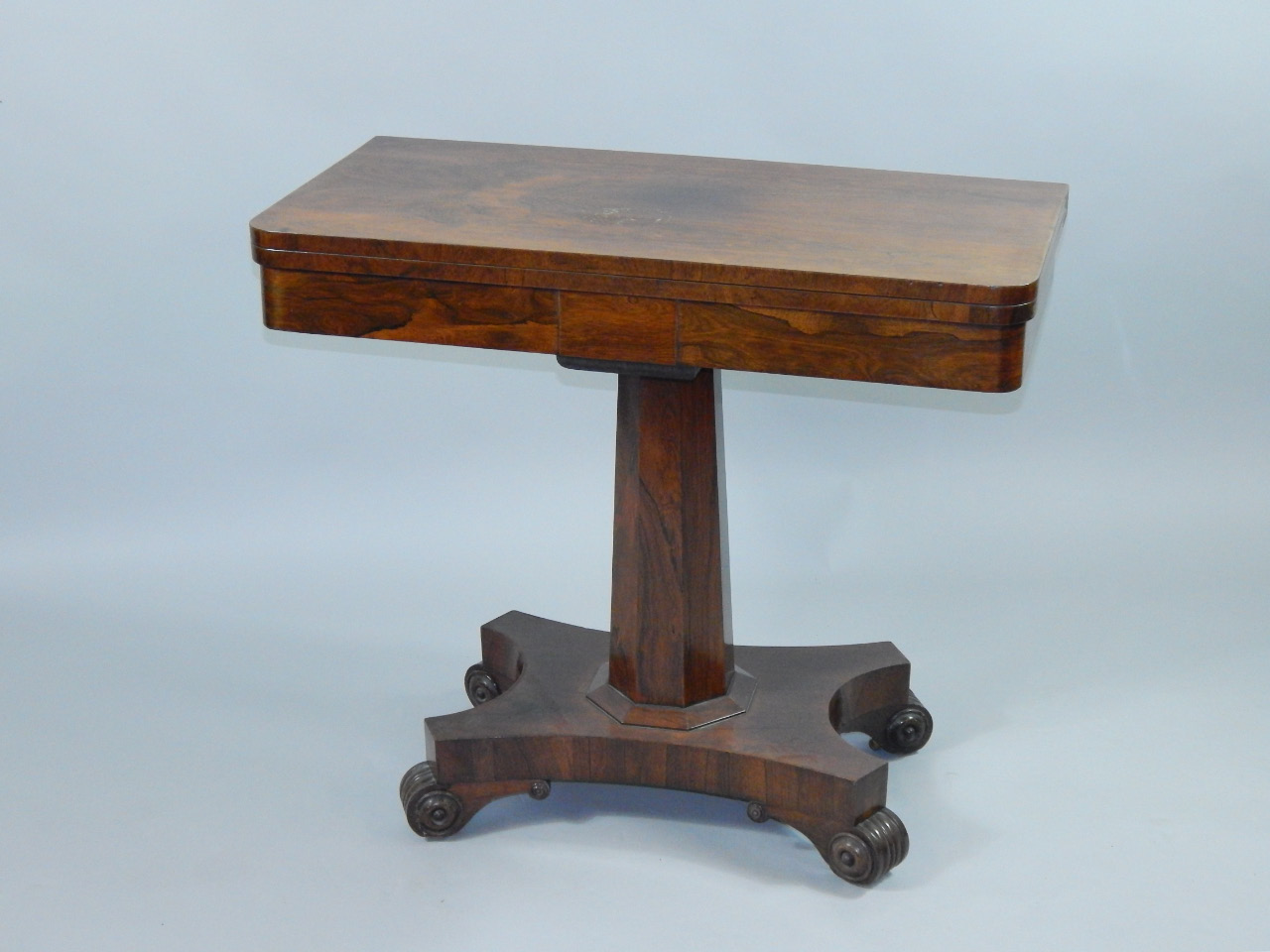 Appraisal: A Regency rosewood demi lune card table the fold over