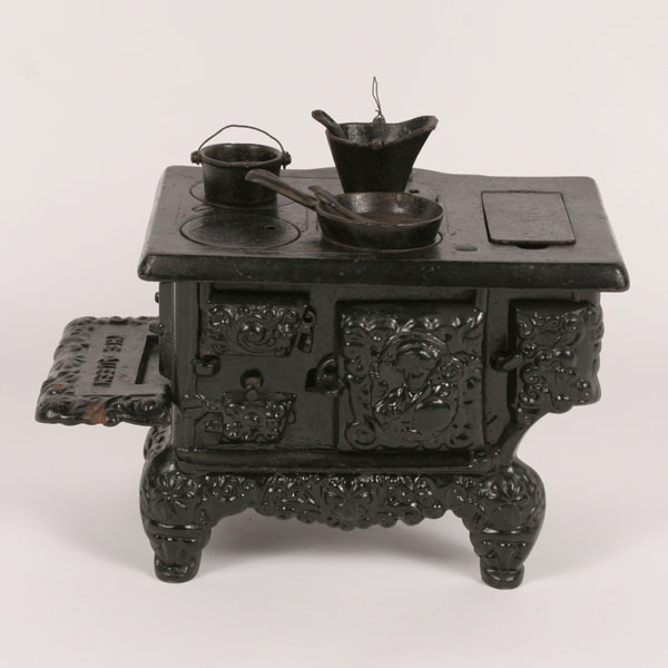 Appraisal: Child's toy stove The Queen cast iron model four lidded