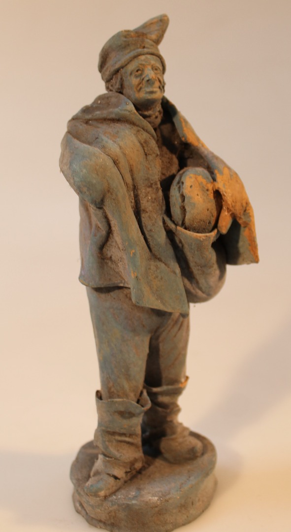 Appraisal: An unusual terracotta figure of a gentleman in flowing robes