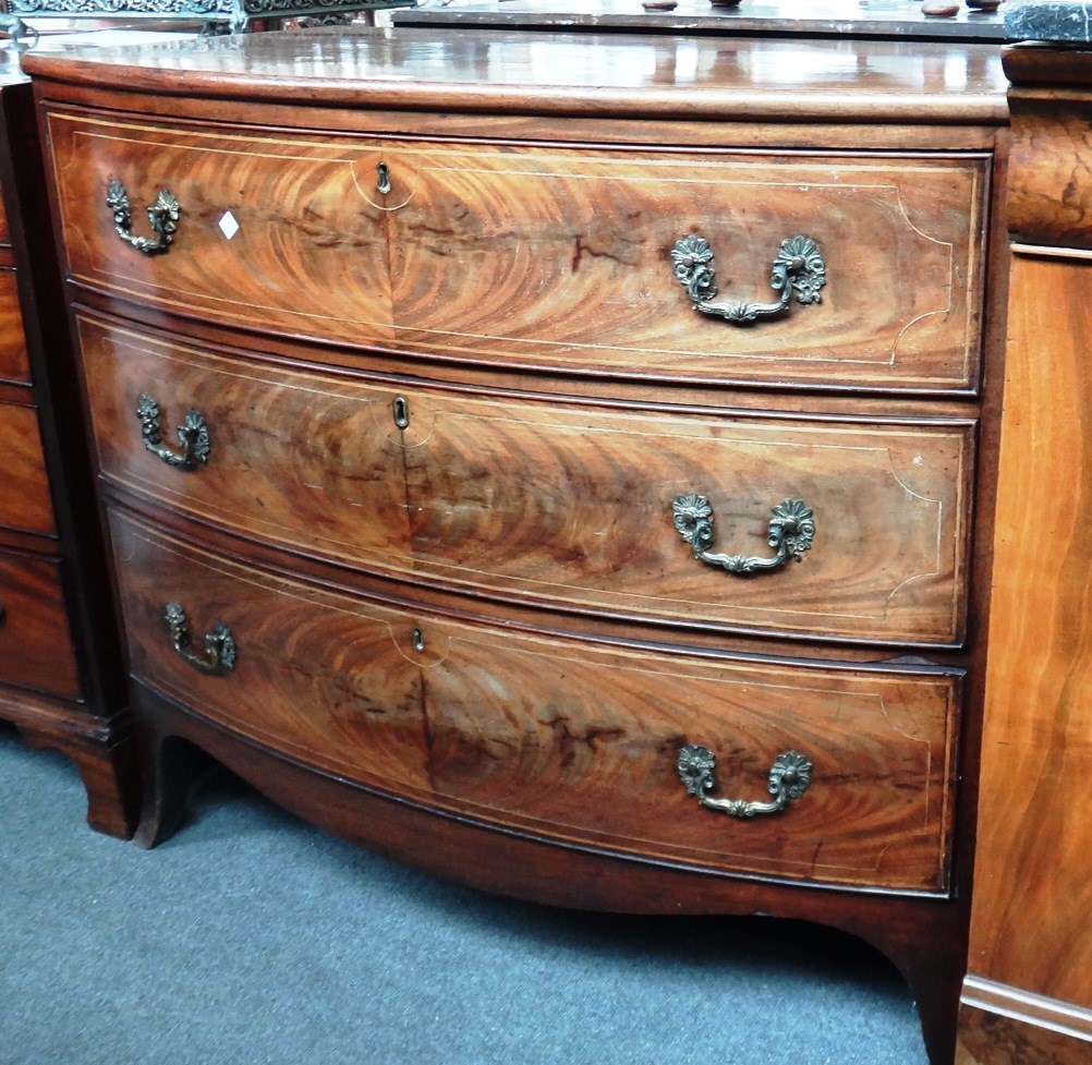 Appraisal: A Regency inlaid mahogany bowfront chest of three long graduated