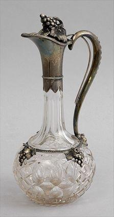 Appraisal: CONTINENTAL SILVER-MOUNTED CUT-GLASS CLARET JUG The spherical diamond-cut bowl with