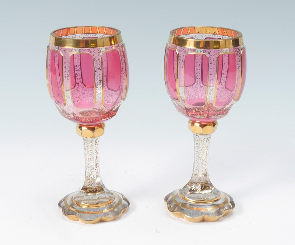 Appraisal: PAIR OF MOSER GOBLETS Classic gold gilding with cranberry panels