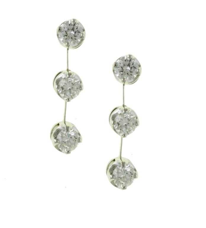 Appraisal: A PAIR OF DIAMOND THREE STONE EARRINGS with evenly sized