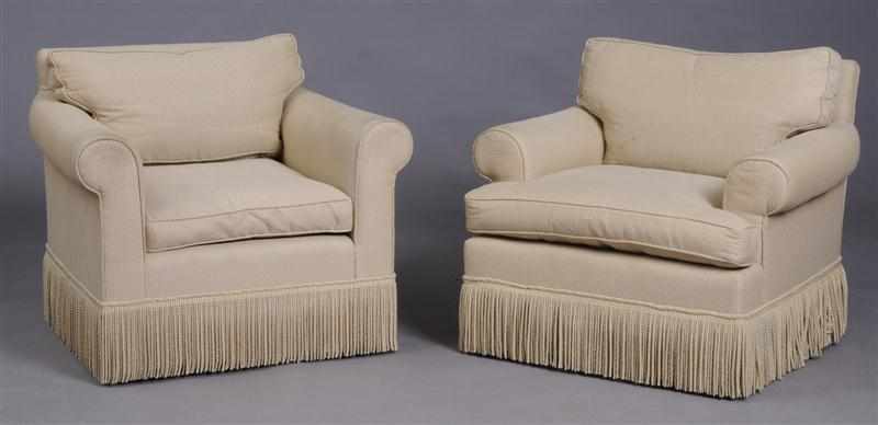 Appraisal: PAIR OF UPHOLSTERED ARMCHAIRS With roll-over armrests and fringed skirt