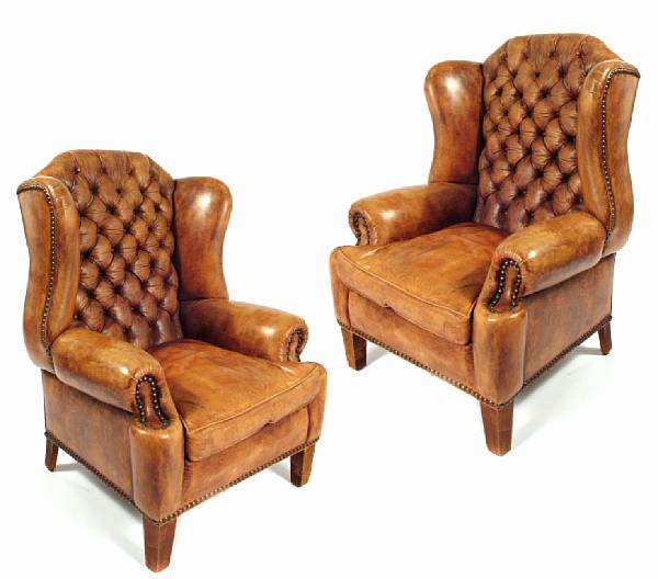 Appraisal: A pair of George III style oversized leather upholstered wingback