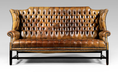 Appraisal: Chippendale style tufted leather-upholstered sofa arched back and rolled arms