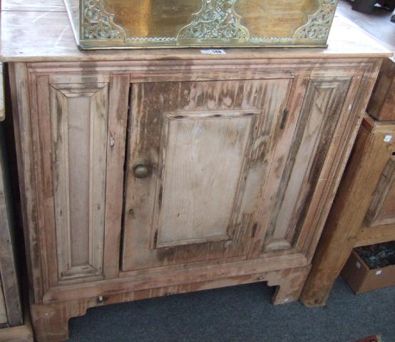 Appraisal: A pine side cupboard with single panel door raised on