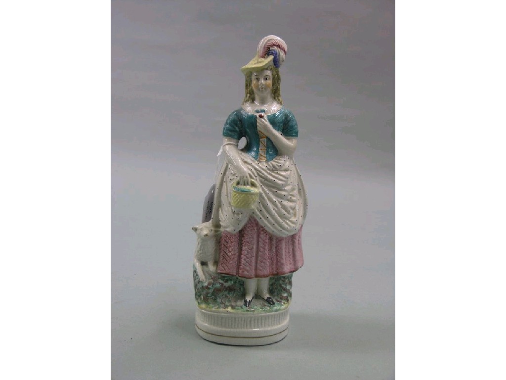 Appraisal: A Victorian Staffordshire pottery figure girl wearing plumed bonnet dog