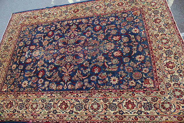 Appraisal: A BLUE GROUND KASHAN SMALL CARPET with scrolling foliate decoration