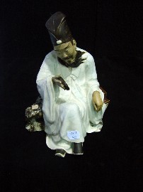 Appraisal: A Japanese figure of a seated scholar in crackle glazed