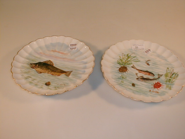 Appraisal: A pair of continental porcelain moulded plates hand painted with