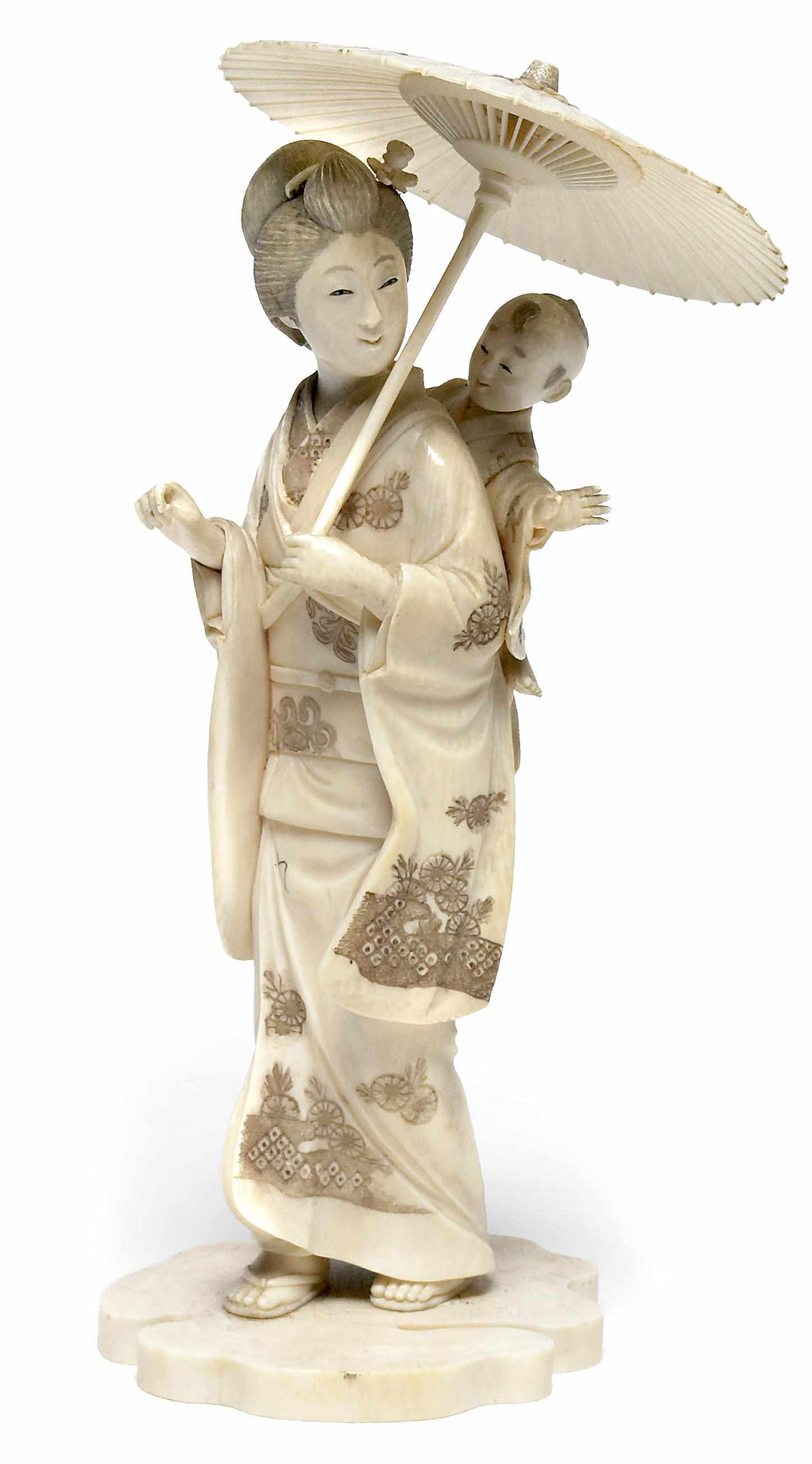 Appraisal: A Japanese ivory okimono Meiji PeriodDepicting a lady with a