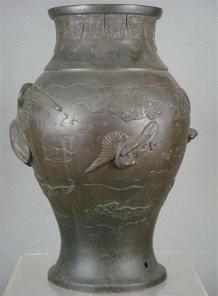 Appraisal: Oriental bronze vase with raised flying bird and cloud decoration