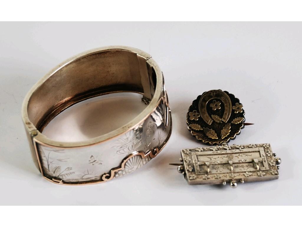 Appraisal: NINETEENTH CENTURY SILVER AND GOLD BROAD HINGE OPENING BANGLE the