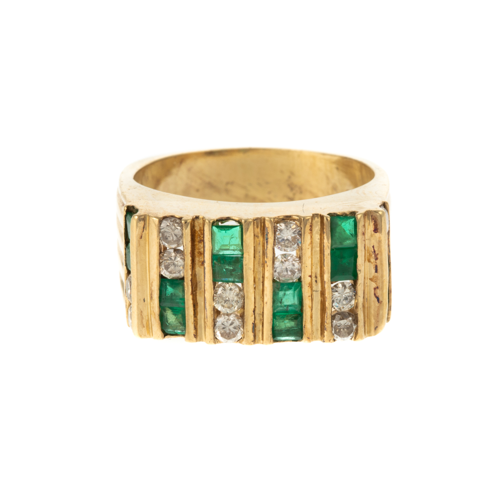 Appraisal: A CHANNEL-SET EMERALD DIAMOND RING IN K K yellow gold