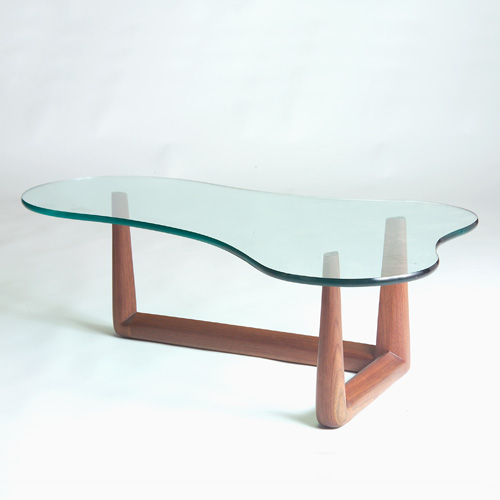 Appraisal: T H ROBSJOHN-GIBBINGS Coffee table with amoeba-shaped glass top on