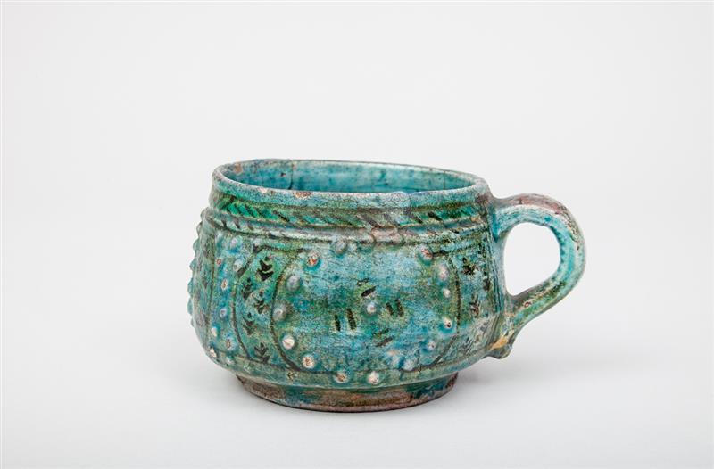 Appraisal: Turkish Turquoise-Glazed Cup With relief rivets and black highlights x