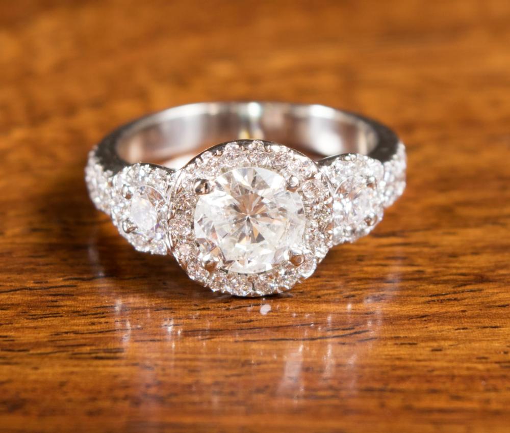 Appraisal: DIAMOND AND FOURTEEN KARAT WHITE GOLD RING with round-cut diamonds