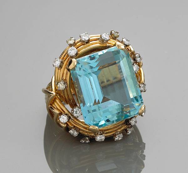 Appraisal: An aquamarine and diamond ring centering a rectangular-cut aquamarine measuring