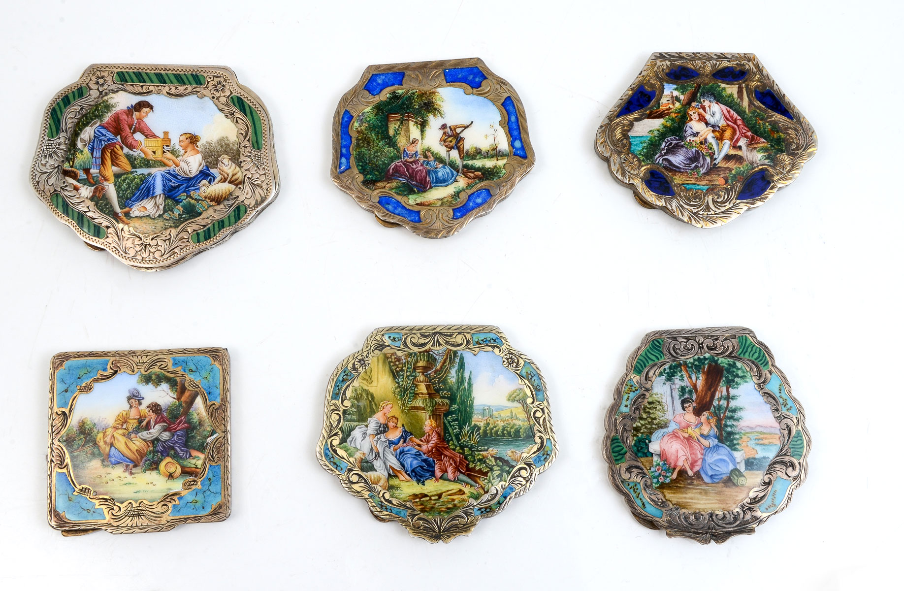 Appraisal: CONTINENTAL ENAMELED GILT SILVER COMPACTS Beautifully done gilt compacts with