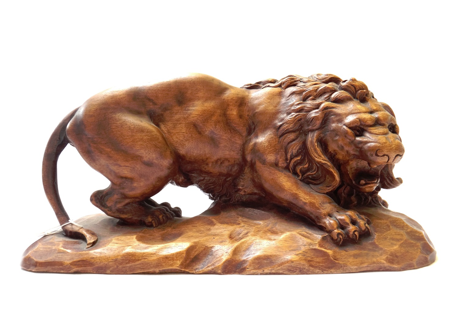 Appraisal: A modern carved hardwood model of a prowling lion on