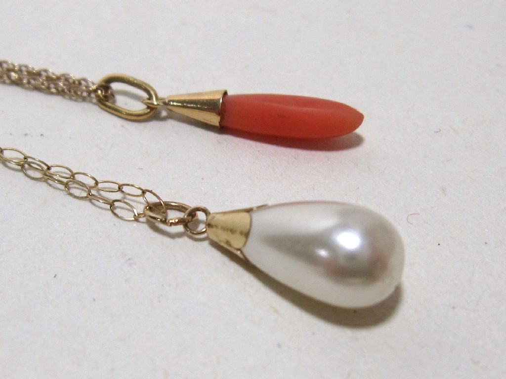 Appraisal: Lot comprising coral pendant and paste pearl pendant both with