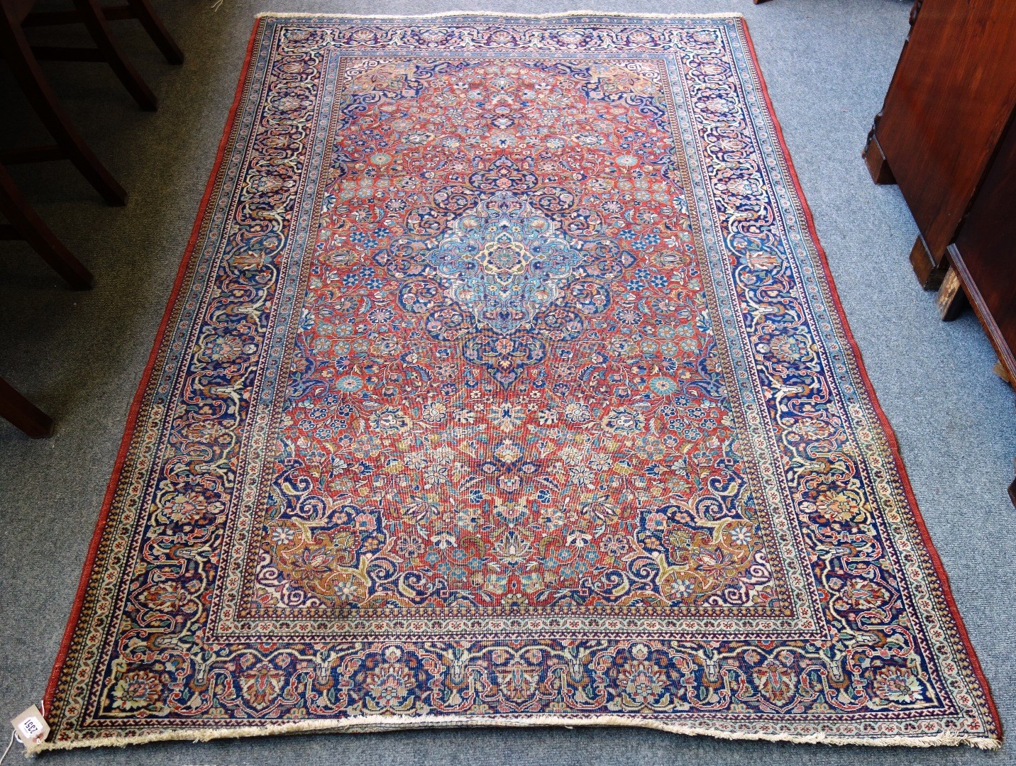 Appraisal: A Kashan rug long red ground with intricate scrolling medallion