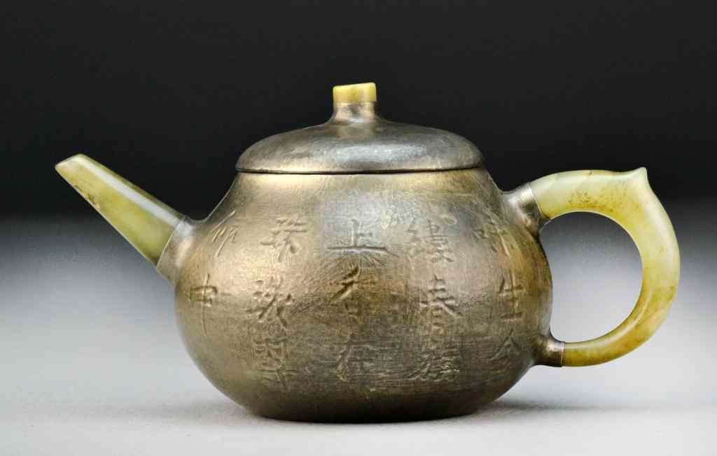 Appraisal: Chinese Pewter Jade Tea PotFinely molded to depict lotus blossoms