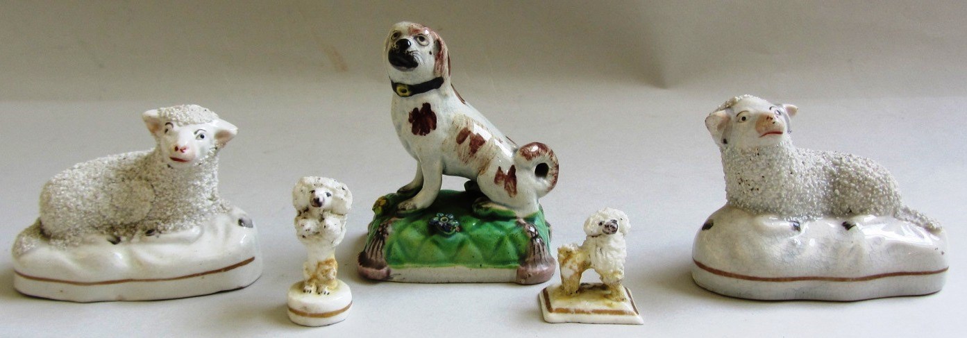 Appraisal: A Staffordshire pearlware model of a dog atop a cushion