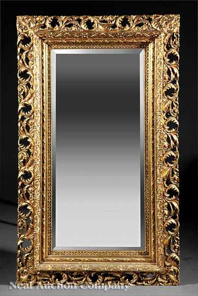 Appraisal: A Continental Rococo-Style Giltwood Mirror pierced foliate border deeply molded