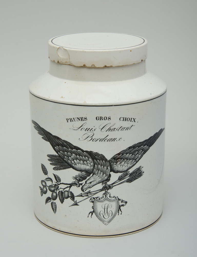 Appraisal: FRENCH TRANSFER-PRINTED FAIENCE CANISTER AND COVER Marked 'Prunes Gros Choix