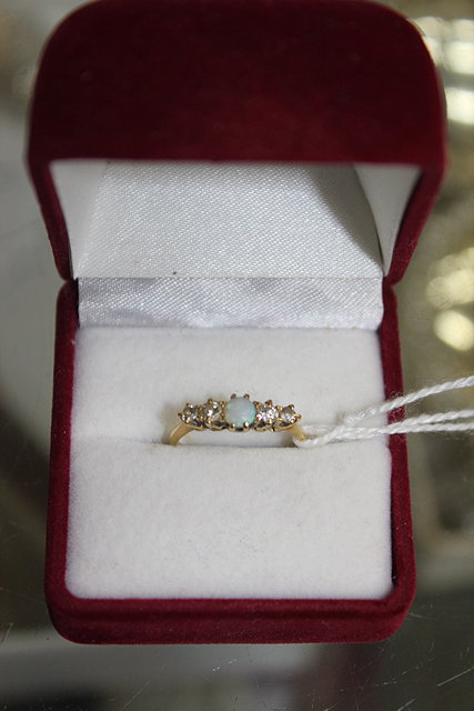 Appraisal: AN CT GOLD ENGAGEMENT RING with central opal flanked by