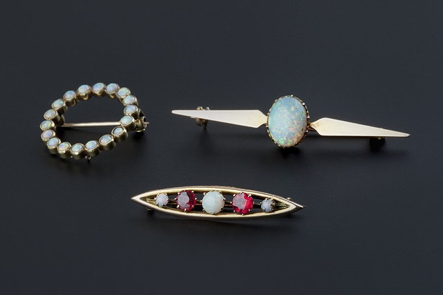 Appraisal: Three opal set brooches comprising an oval cabochon opal bar