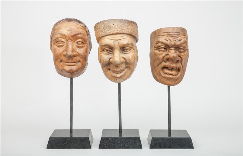 Appraisal: Three Pottery Hanging Heads Each on metal rod fitted into