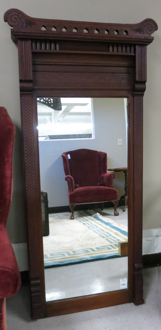 Appraisal: VICTORIAN WALNUT-FRAMED WALL MIRROR Eastlake style American c a rectangular