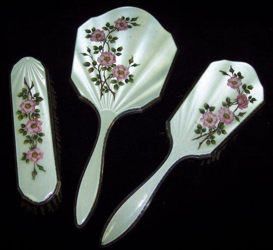 Appraisal: A dressing table set comprising two brushes and a hand